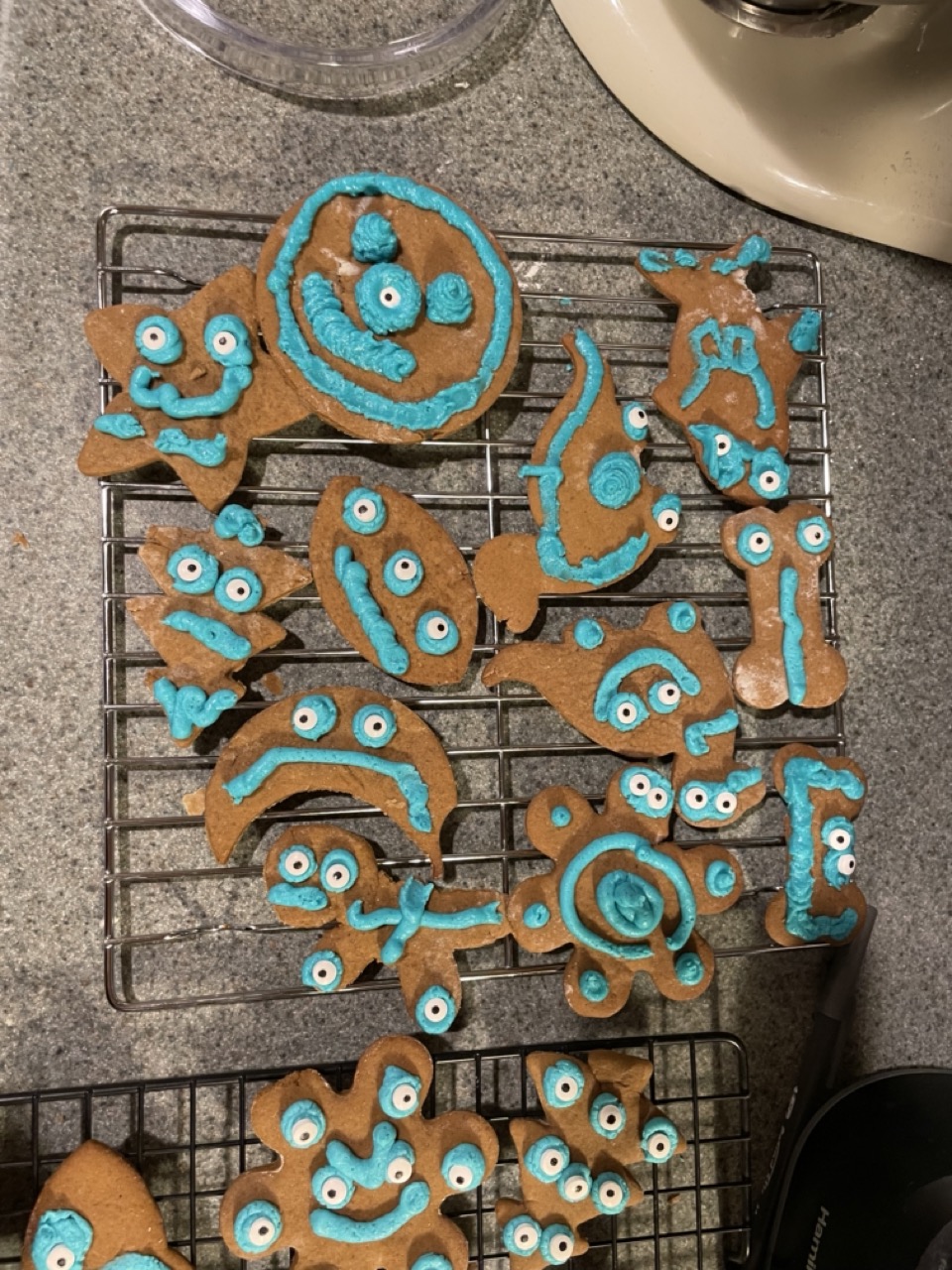 The last of the teal-iced gingerbread monster cookies on a cooling rack.